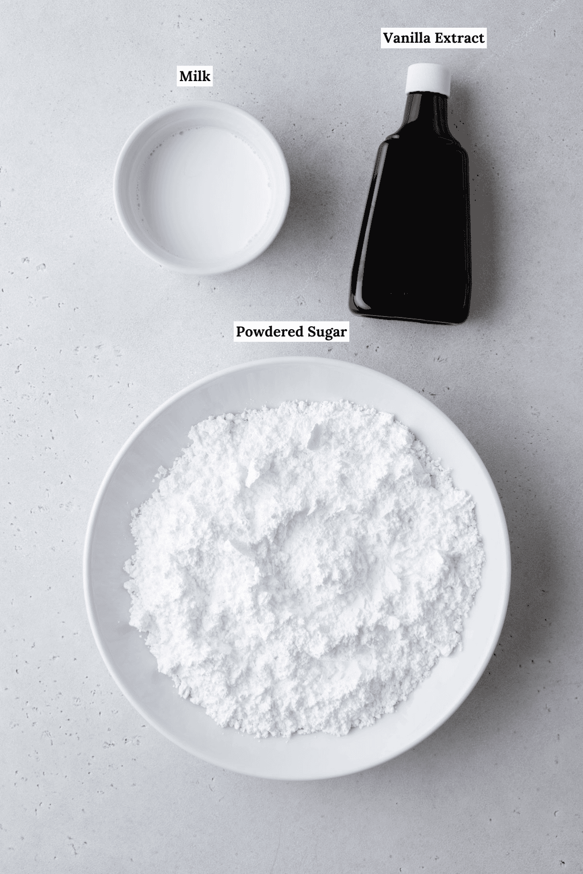 overhead view of the ingredients for donut glaze including milk, vanilla extract, and powdered sugar