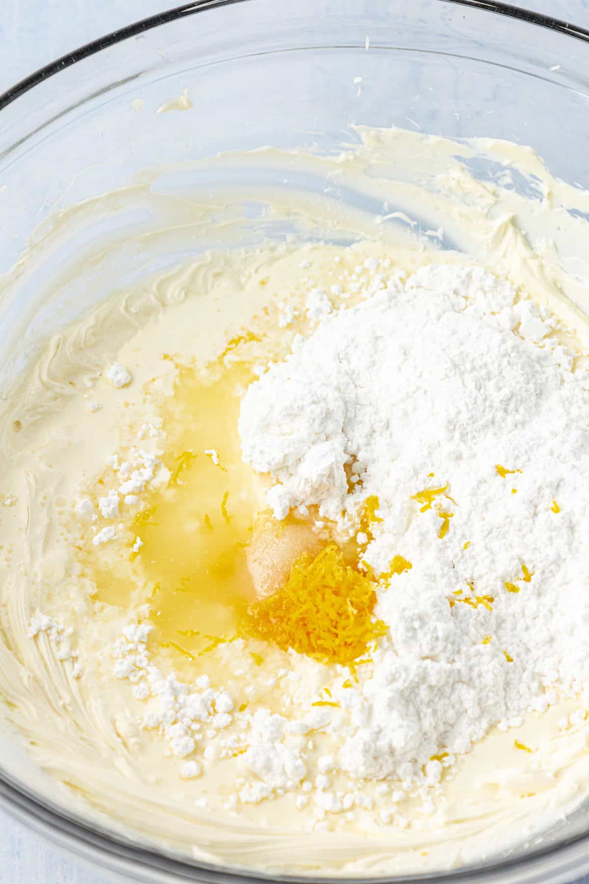 ingredients for lemon frosting in a clear glass bowl