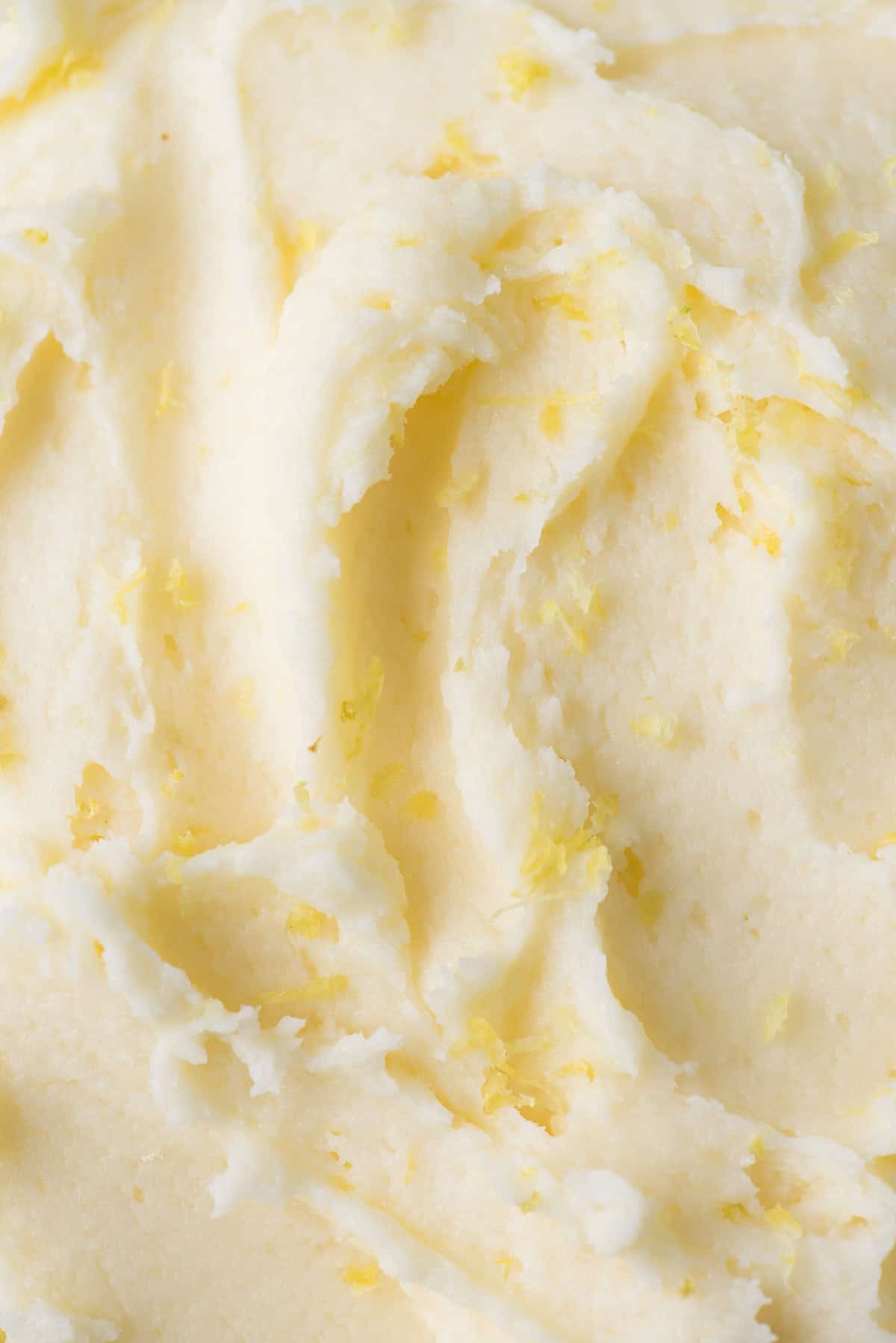 close up of lemon frosting sprinkled with lemon zest