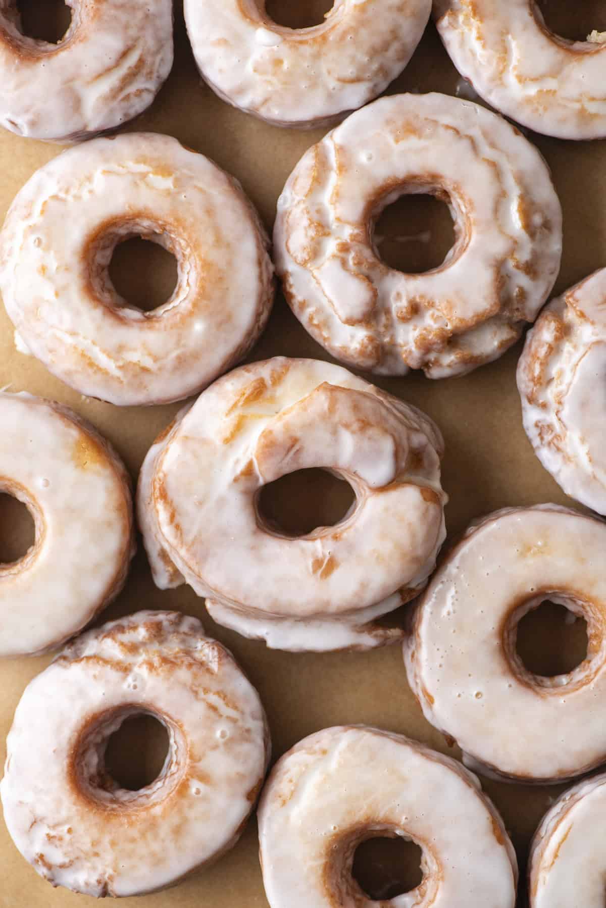 over head view of old fashioned donuts on a brown paper surface