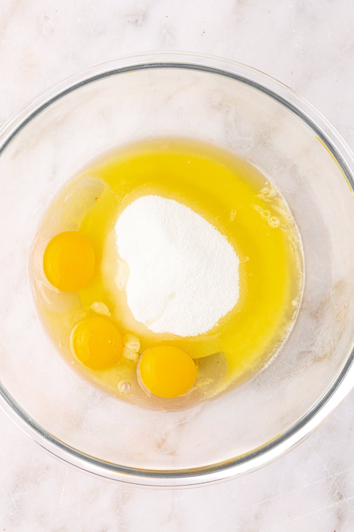 eggs, sugar and butter in a clear glass mixing bowl