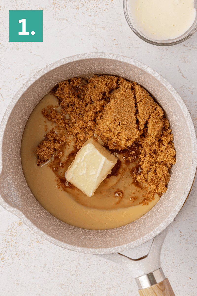 A saucepan with a block of butter, brown sugar, and condensed milk inside, ready to be mixed. A small glass bowl with a creamy mixture sits nearby. The image is labeled with a green box and the number 1 in the top left corner.
