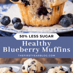 A close-up of a blueberry muffin with whole blueberries, sitting on a plate, and more fresh muffins in a baking tin below. Text overlay reads: “50% less sugar. Healthy Blueberry Muffins.”.