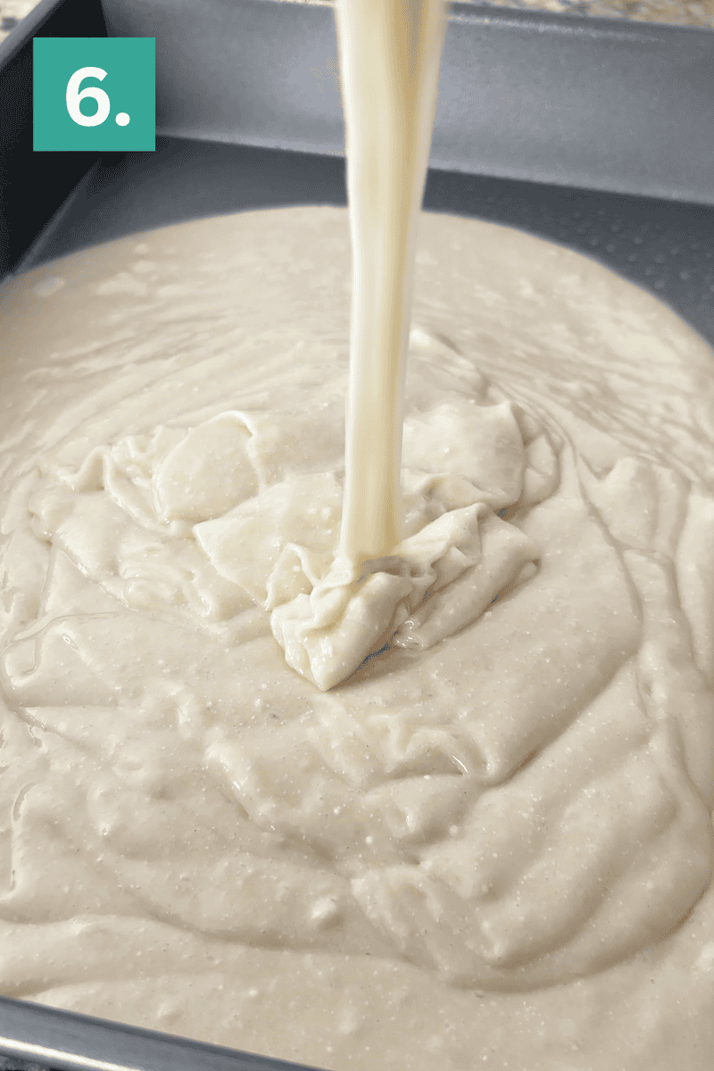 Cake batter being poured into a greased baking pan, with a teal box in the corner displaying the number 6.