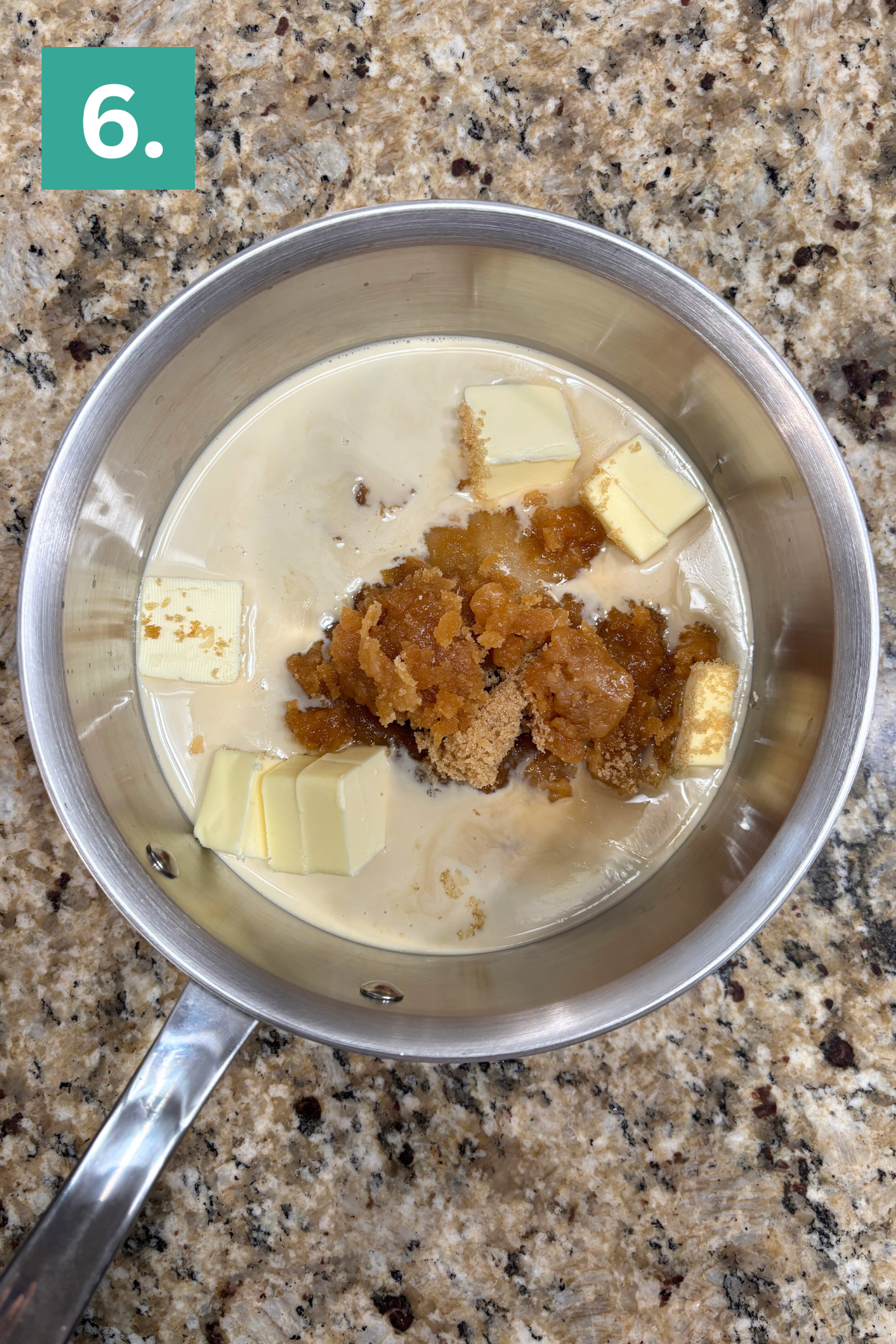 A saucepan on a granite countertop contains milk, cubed butter, and brown sugar. A green box with the number 6 is in the top left corner of the image.