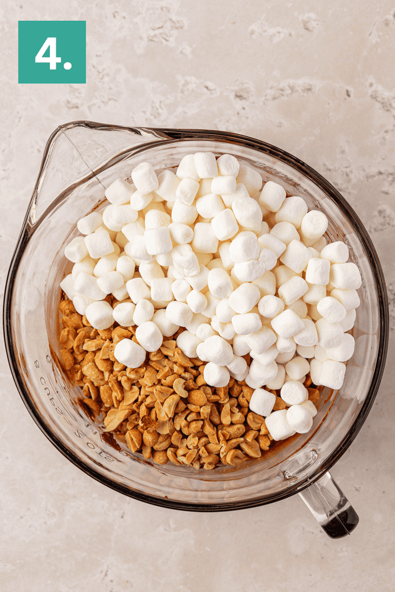 A glass mixing bowl filled with mini marshmallows and chopped peanuts sits on a light-colored countertop. A green square with the number 4 is in the top left corner.