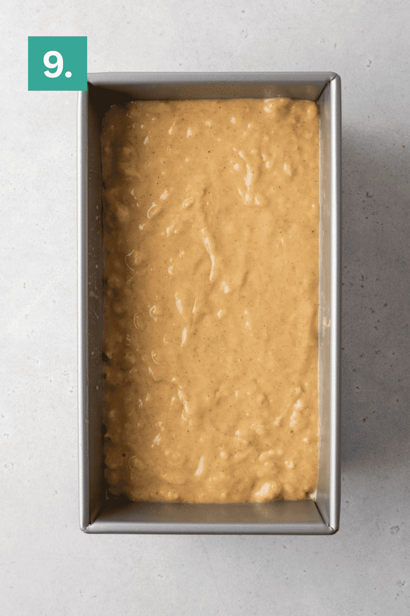 A rectangular loaf pan filled with banana bread batter sits on a light gray surface. A green box with the number 9 is in the top left corner of the image.
