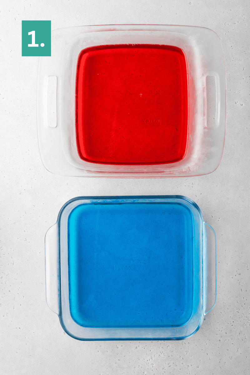 Two square glass baking dishes sit on a light surface. The top dish contains red gelatin, and the bottom dish contains blue gelatin. A green box labeled “1.” is in the top left corner.
