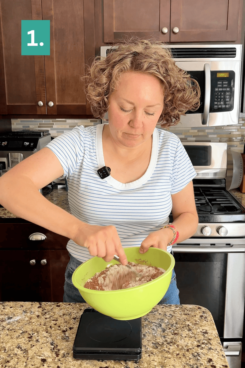 A woman in a striped shirt mixes ingredients in a green bowl in a kitchen, standing at a counter near a stove. The image is labeled “1.” in the top left corner.