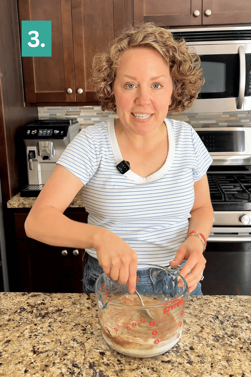 A woman wearing a striped shirt stirs ingredients in a glass measuring cup on a kitchen counter. A number 3. is shown in a green box in the corner.