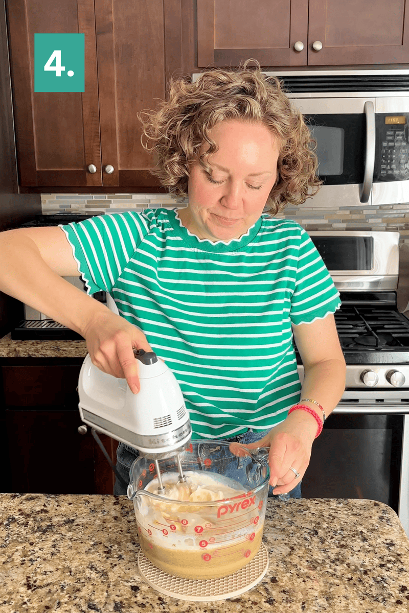 A woman in a green striped shirt uses a hand mixer to blend ingredients in a Pyrex bowl on a kitchen counter. A green box labeled 4. appears in the top left corner.
