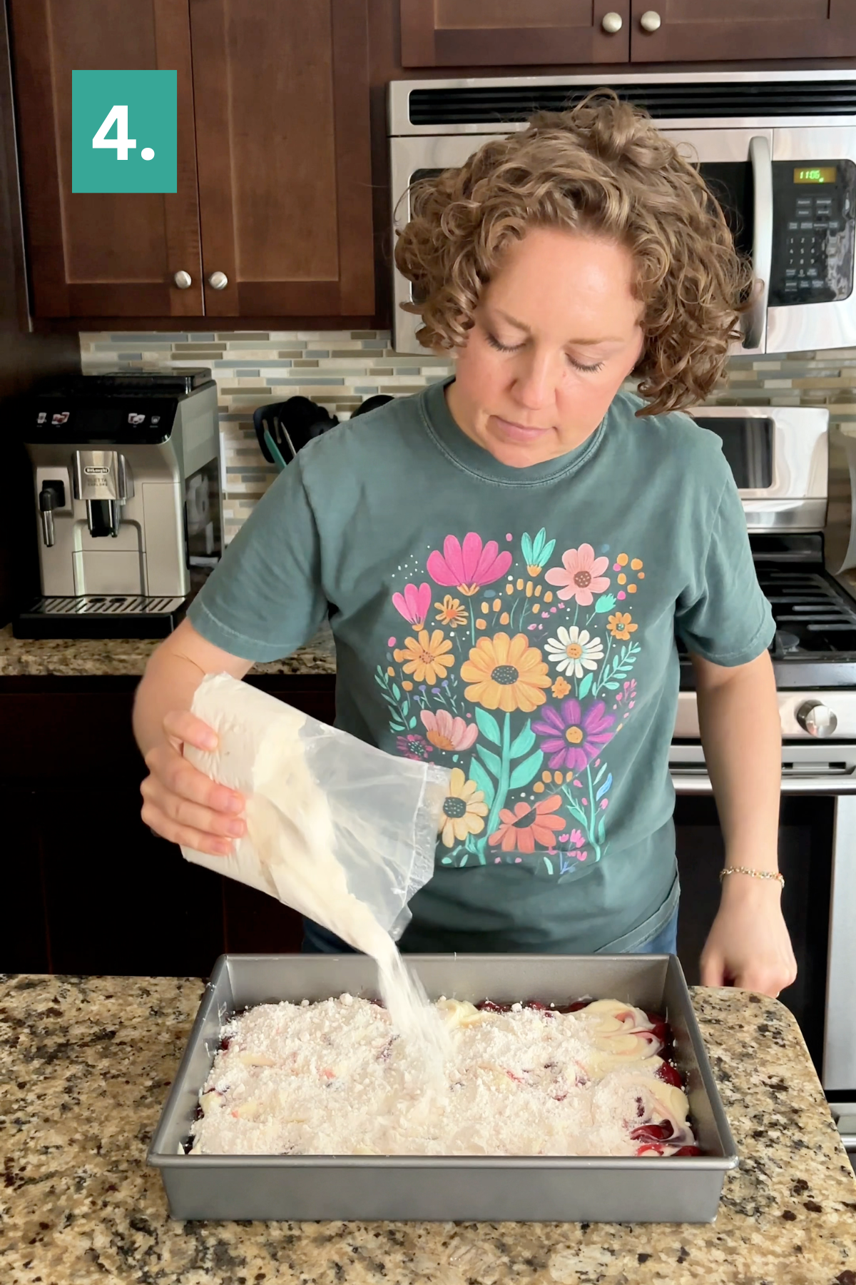 A person pours a white powder from a bag into a baking pan in a kitchen, preparing to make a Strawberry Cheesecake Dump Cake. They wear a teal shirt with colorful flowers. The number 4. appears in the corner.